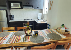 Elegant dining area with a modern table and comfortable chairs, designed for shared meals in a cozy atmosphere.