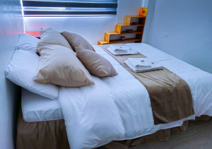 Cozy second bedroom with a comfortable bed, modern furnishings, and a tranquil atmosphere.