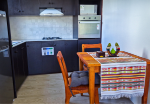 Fully equipped kitchen and dining area in Seashell Suite.