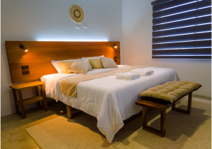 Cozy and stylish bedroom with a comfortable bed, soft lighting, and a relaxing ambiance.