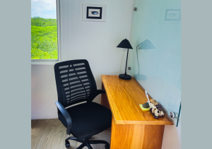 Dedicated workspace with a comfortable desk and chair, ideal for remote work.